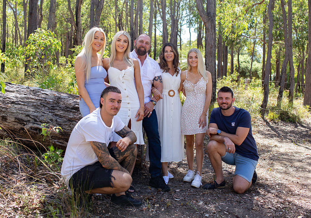 Family photography. Photo of adult family in the bush